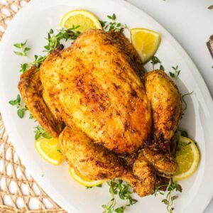 Air Fryer Whole Chicken with slices of lemons