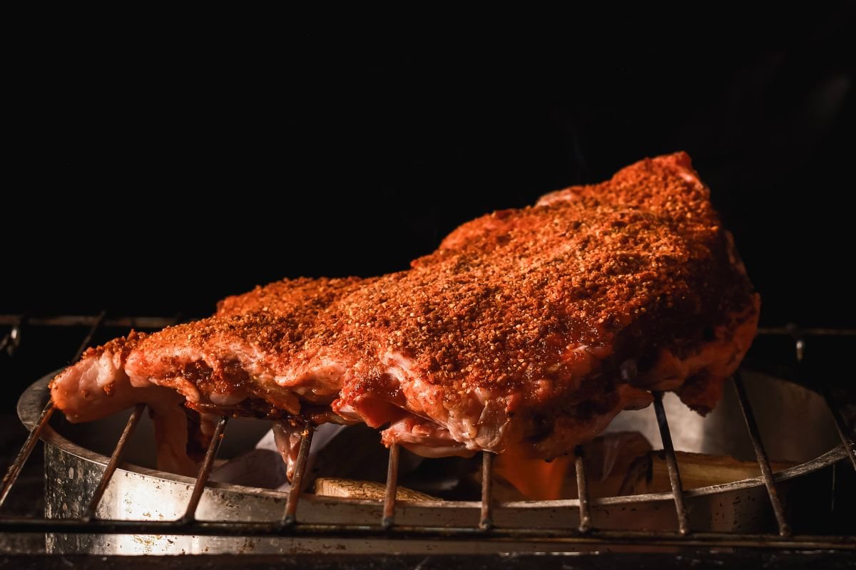 Beef Brisket on a grill with seasoning