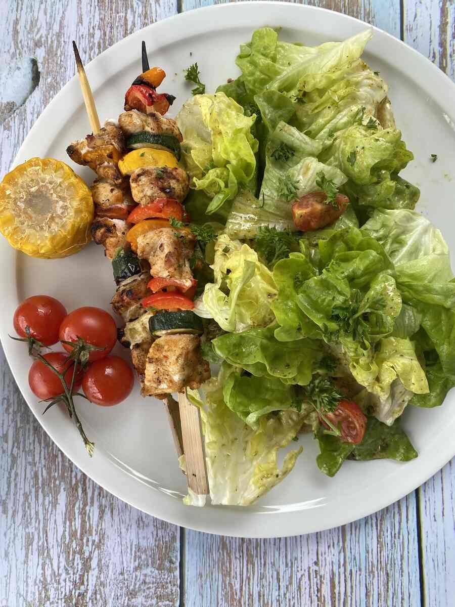 Chicken Kebab with salad served in a plate.