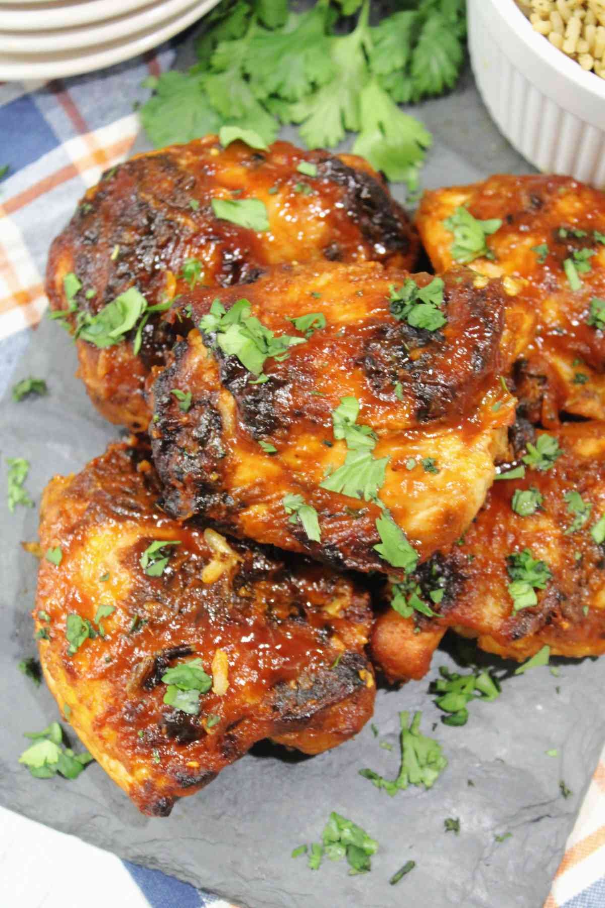 Grilled Indian Butter Chicken garnished with chopped parsley.