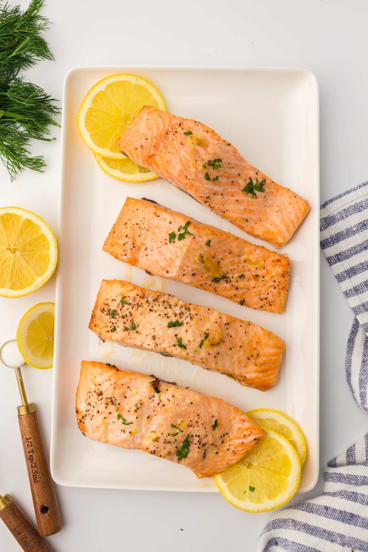 salmon fillets on a platter with lemons